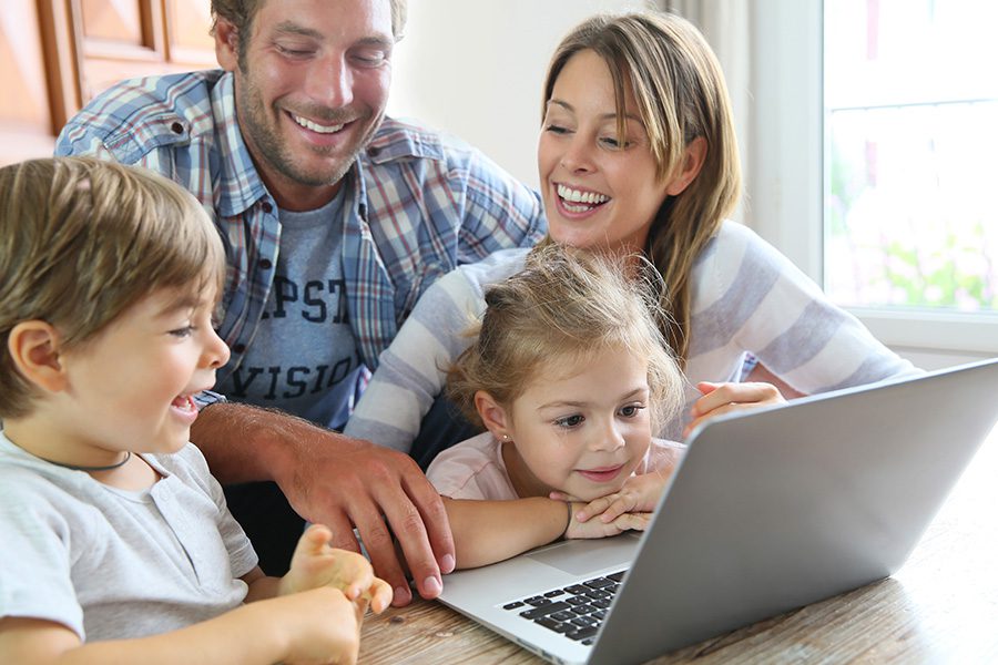 Client Center - Parents With Kids at Home are Using a Laptop to Video Chat