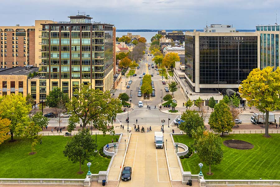 Contact - Aerial Street View of Madison City in Wisconsin Displaying Business Buildings, City Intersections and a Park