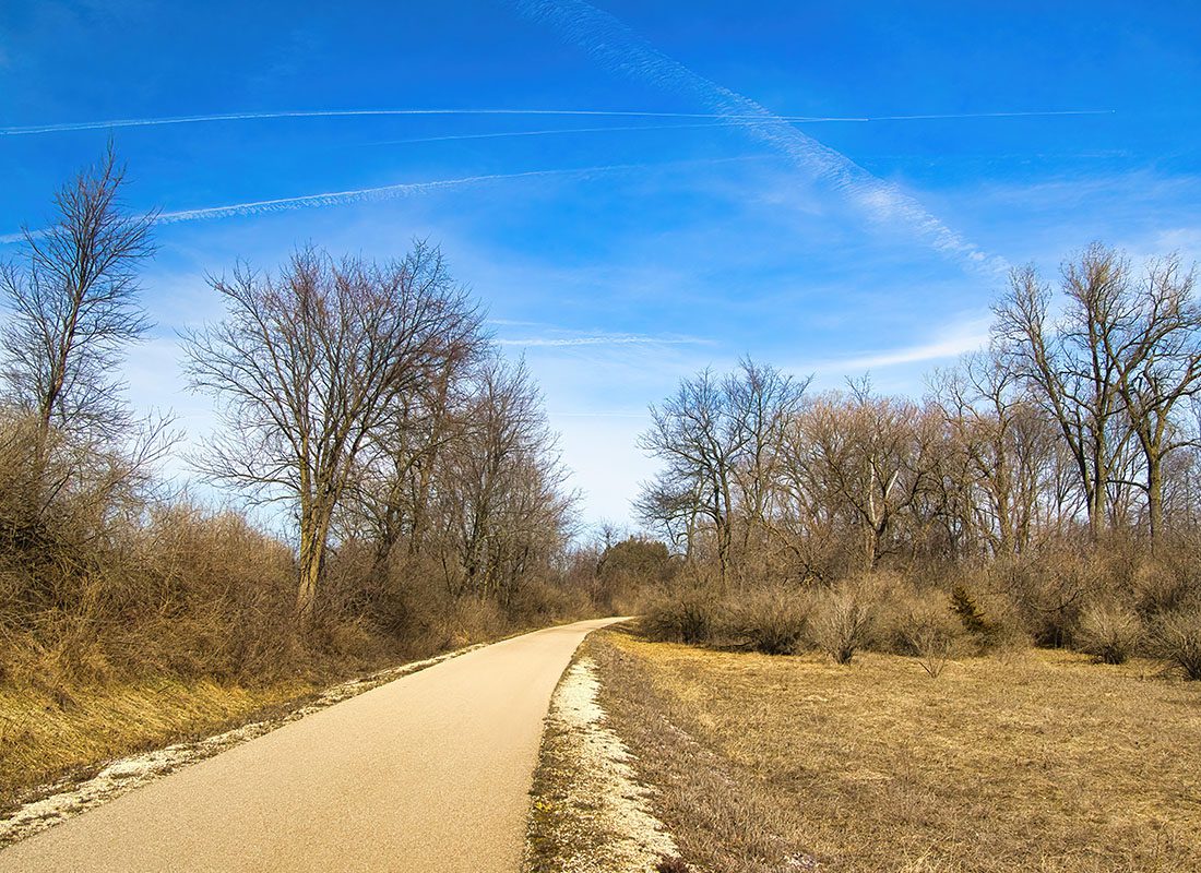 Prairie du Sac WI - Early Spring landscape of the Great Sauk Trail passing through a forest on a sunny day near Prairie du Sac, Wisconsin